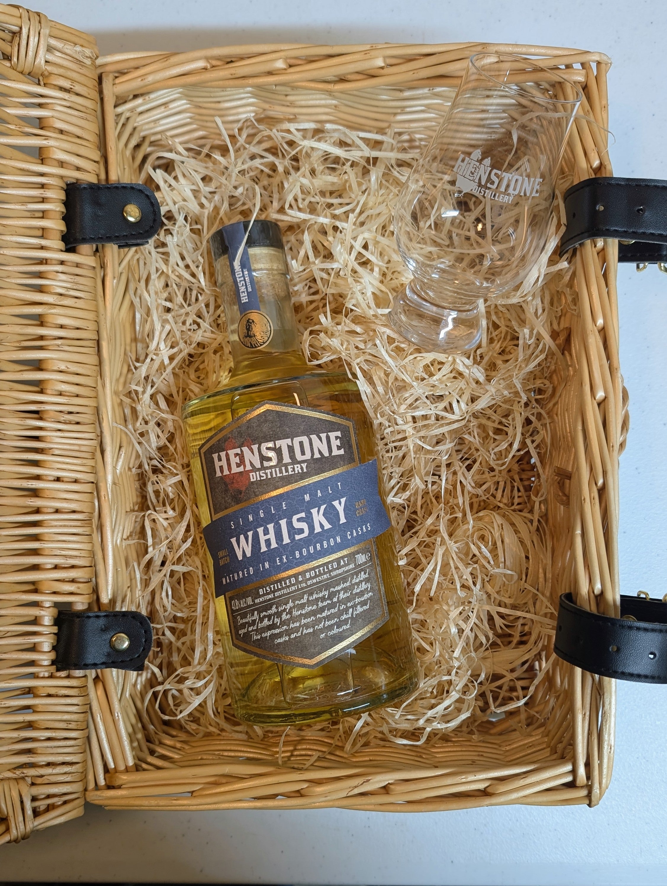 Henstone whisky bottle and glass in a wicker gift basket